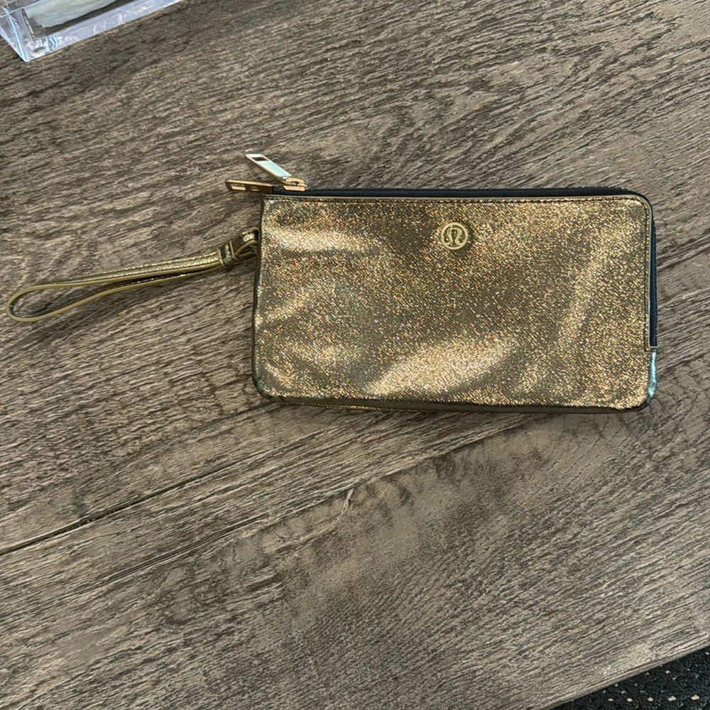 Gold Lululemon wristlet wallet. No tags but never used and in perfect condition.